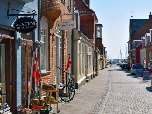 a street with buildings and a bike parked on the sidewalk at 6 person holiday home in Ringkøbing-By Traum in Søndervig