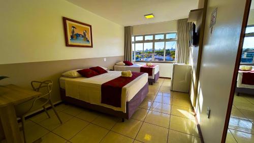 a hotel room with a bed and a window at Max Hotel in Brasilia