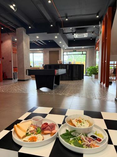 two plates of food on a table in a room at The Hammock Hotel Global City in Ho Chi Minh City