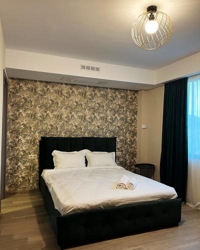 a bedroom with a large bed with a black headboard at Ateni Hills in Gori