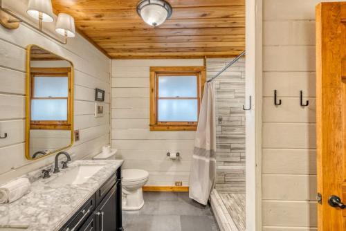 a bathroom with a sink and a toilet at Eagles Haven - Two Cabins with Massive Deck & Views in Blue Ridge