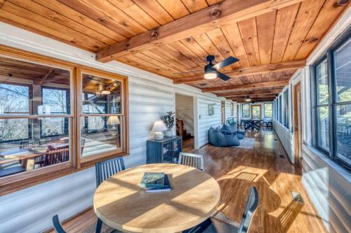 a dining room with a wooden table and chairs at Eagles Haven - Two Cabins with Massive Deck & Views in Blue Ridge
