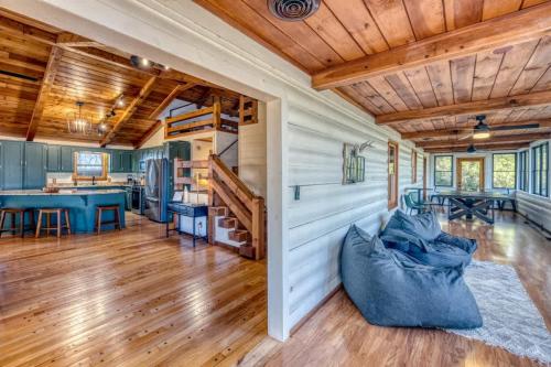 a living room with wooden ceilings and a staircase at Eagles Haven - Two Cabins with Massive Deck & Views in Blue Ridge