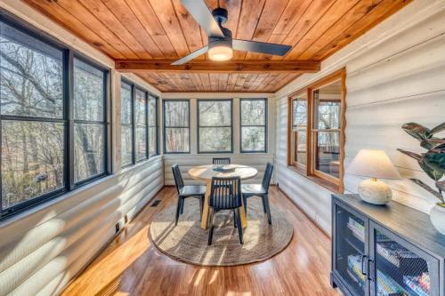 a dining room in a tiny house with a ceiling fan at Eagles Haven - Two Cabins with Massive Deck & Views in Blue Ridge