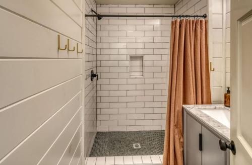 a white bathroom with a shower and a sink at Eagles Haven - Two Cabins with Massive Deck & Views in Blue Ridge
