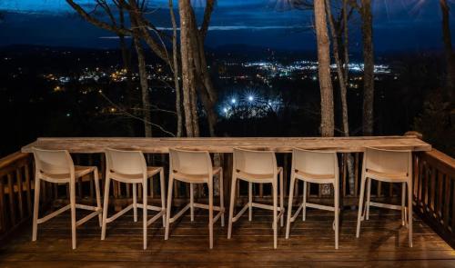 a table and chairs on a deck at night at Eagles Haven - Two Cabins with Massive Deck & Views in Blue Ridge