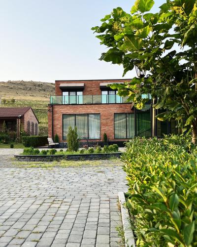 a brick house with a brick driveway in front of it at Ateni Hills in Gori