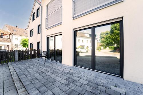 a patio with large glass doors on a building at Select-Home 2 - Netflix - Kaffee&Tee - Parkplatz - viele Extras in Bruck in der Oberpfalz