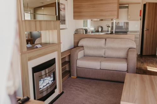 a living room with a couch and a fireplace at Lower Cliff 9 in Portland