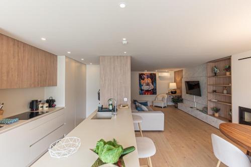 a kitchen and living room with a table and chairs at GuestReady - Elegant beachside stay in Apúlia in Apúlia