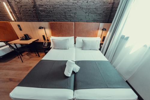 a large bed in a room with atained at Hotel Transit in Barcelona