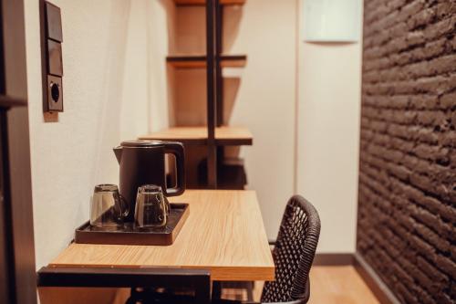 a table with a coffee maker on top of it at Hotel Transit in Barcelona