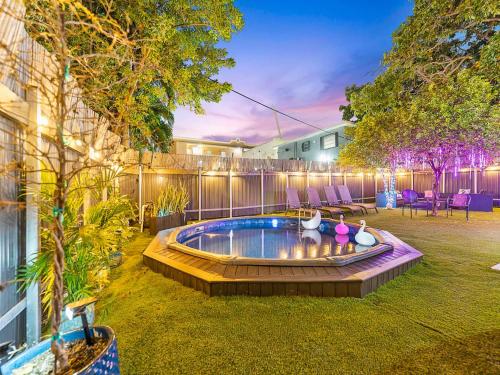 a backyard with a hot tub in the grass at Villa Tranquillo Calle Ocho Pool & Hot Tub in Miami