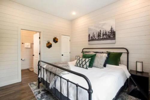 a bedroom with a bed with green pillows at Whispering Pine - Arcade - Lake Perks in Sevierville