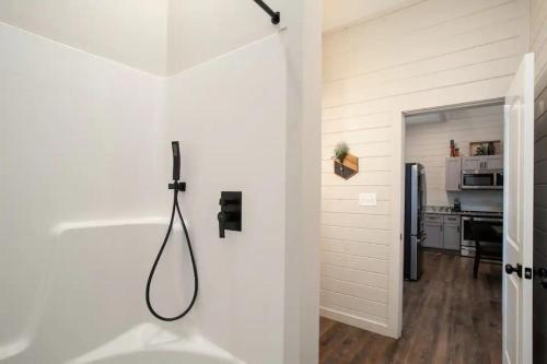 a shower in a bathroom with a white wall at Whispering Pine - Arcade - Lake Perks in Sevierville