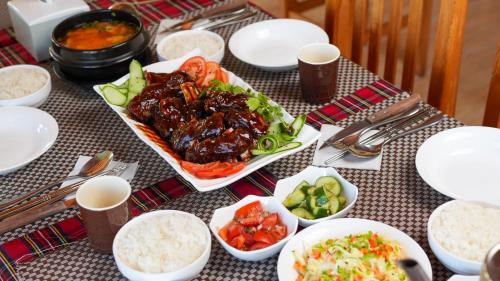 a table with plates of food and bowls of food at Bayankhad Star Lodge in Dugang Süme