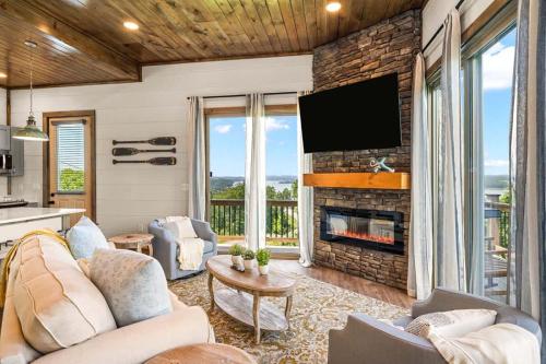 a living room with a fireplace and a tv at Lake View Serenity - Indoor Pool - Arcade - Lake in Sevierville