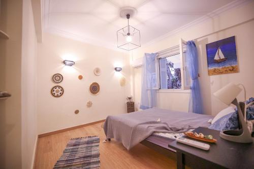 a bedroom with a bed and a table and a window at Sunny Garden Apartment in central kolonaki Athens in Athens