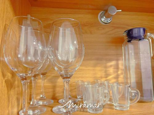 a group of wine glasses sitting on a table at Vert House Jardim Oceania - Miramar Hospedagens in Tambaú