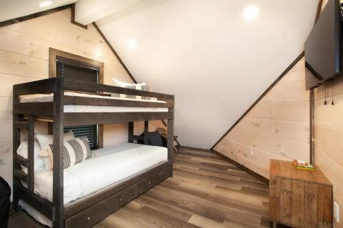 a bedroom with two bunk beds in a attic at Mountain Waters - Pool Theater & Views in Sevierville