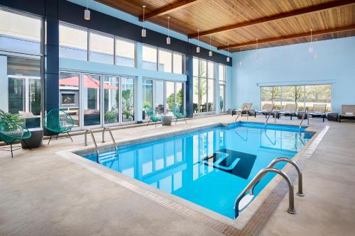 a large pool with blue water in a building at Aloft Montreal Airport in Dorval