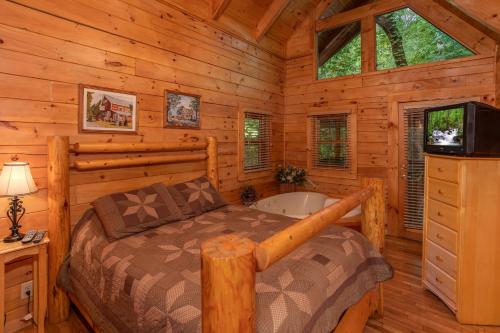 a bedroom with a bed and a tub in a cabin at Dreams Do Come True by American Patriot Getaways in Cartertown