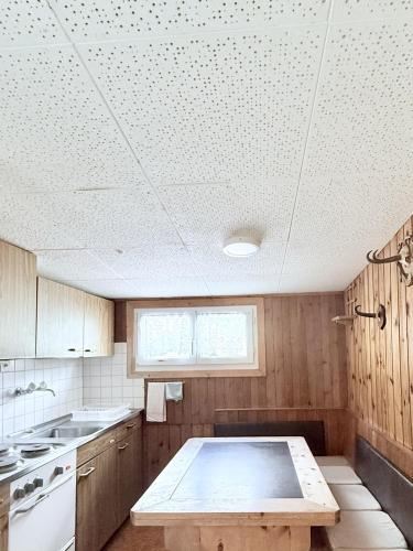 a kitchen with a table in the middle of it at Hotel Guidon Apartments in Bivio
