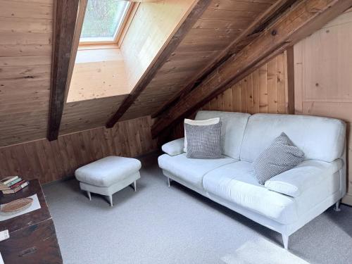 a living room with a white couch and a window at Hotel Guidon Apartments in Bivio