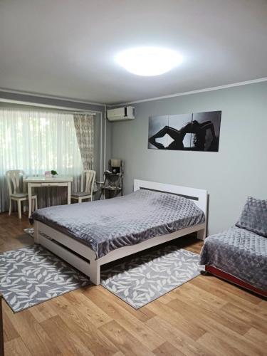 Un dormitorio con una cama y una mesa y sillas. en Lux apartment Prospect Central, en Mykolaiv
