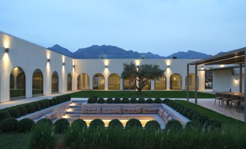 a courtyard with a couch in the middle at Ivory House Resort - Ophiolite in Hatta