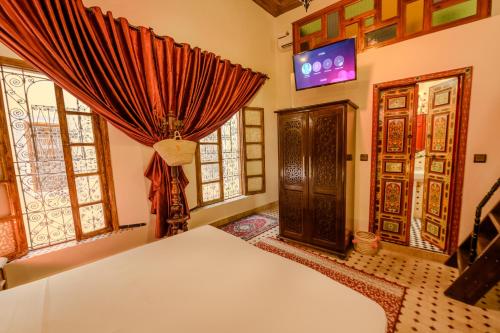 a living room with a door and windows at Riad Diamant De Fes in Fès
