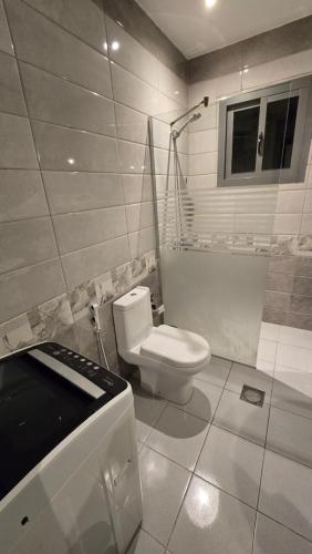 a bathroom with a toilet and a shower and a sink at Marwa Residance in Jeddah