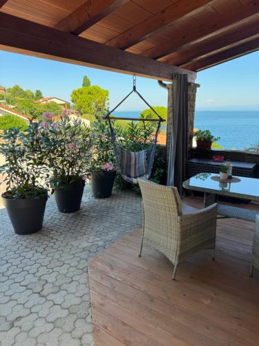 a patio with chairs and a table and some plants at Apartment Emma in Piran