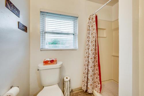 a bathroom with a toilet and a window at Walkable to FSU Campus Cozy Retreat with Deck! in Tallahassee