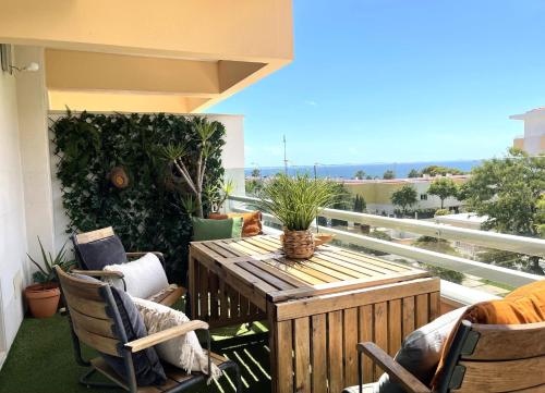 a patio with a table and chairs on a balcony at Lux Apt in Priv Condo with Pool, near Beach, Parking & Easy Access to Lisbon in Parede