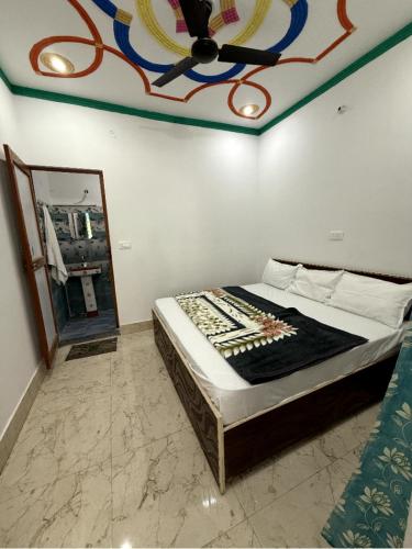a bedroom with a bed with a painting on the ceiling at maa kalishila home stay in Ukhimath