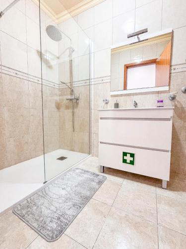 a bathroom with a shower and a sink at Casa da Bela Vida in Calhetas