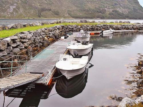 three boats are docked at a dock in the water at 7 person holiday home in Selje-By Traum in Selje