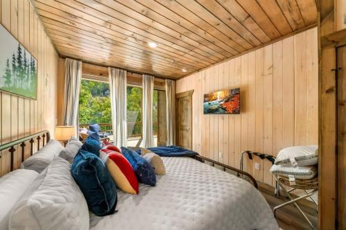 a bedroom with a large bed with pillows on it at Bobber Bungalow - Boat Float Relax in Sevierville