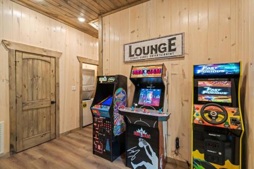 a room with two video game machines next to a door at Bobber Bungalow - Boat Float Relax in Sevierville