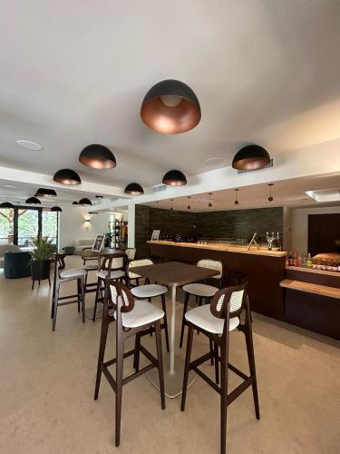 a restaurant with tables and chairs and a bar at Hob La Truffière in Gignac