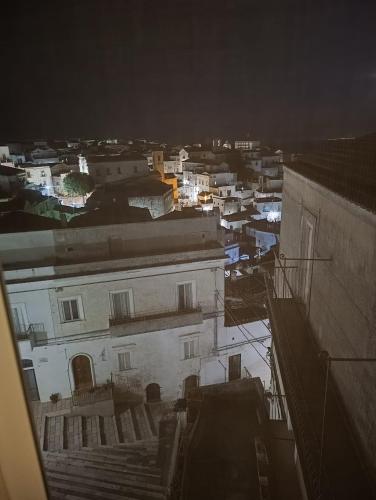 a view of a city at night with buildings at Domus MiTo in Monte SantʼAngelo