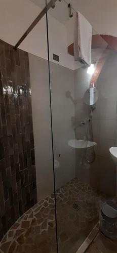 a bathroom with a shower with a glass door at Ubika Hotel in Porto San Giorgio