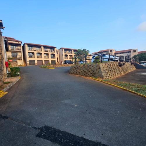 an empty street in front of a building at Ocean View Villas F3 in Port Edward
