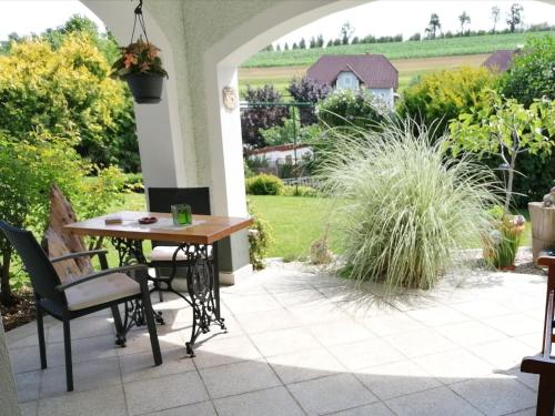 a patio with a table and chairs and a garden at Apartment in Oed-Öhling near Danube River in Mauer bei Amstetten