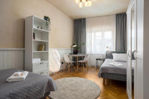 a small bedroom with two beds and a table at 1800 by Vince Stay - Private Rooms in Town Hall Square in Tartu