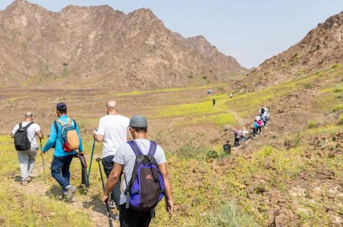 a group of people walking on a mountain trail at Ivory House Resort - Ophiolite in Hatta