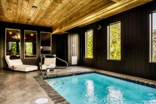 a swimming pool in a home with a wooden ceiling at Midnight Mountain in Sevierville