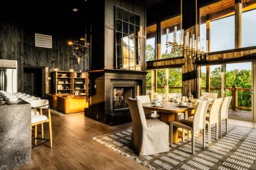 a dining room with a fireplace and a table and chairs at Midnight Mountain in Sevierville