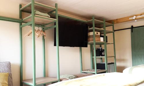 a room with two green bunk beds and a bed at Arbors at Island Landing Hotel & Suites in Pigeon Forge